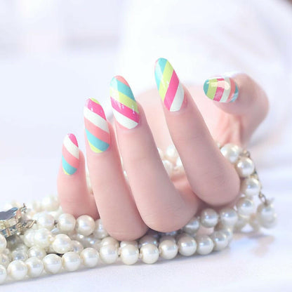 Manicured nails with pastel striped nail art featuring diagonal green pink coral stripes