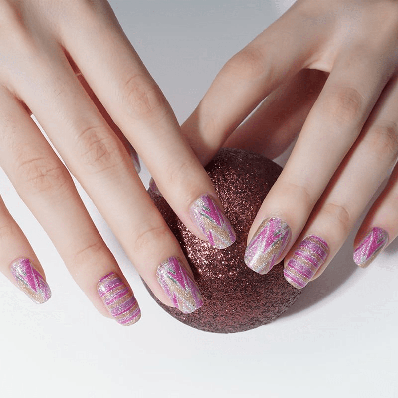 Pink watercolour stripe nail wraps on hands with glitter holographic finish