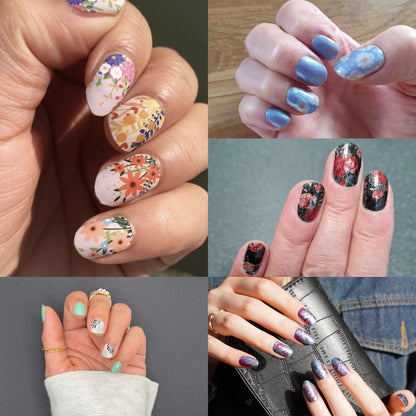 Hand wearing mixed floral nail art wraps showing botanical patterns in multicolour designs for at-home manicures
