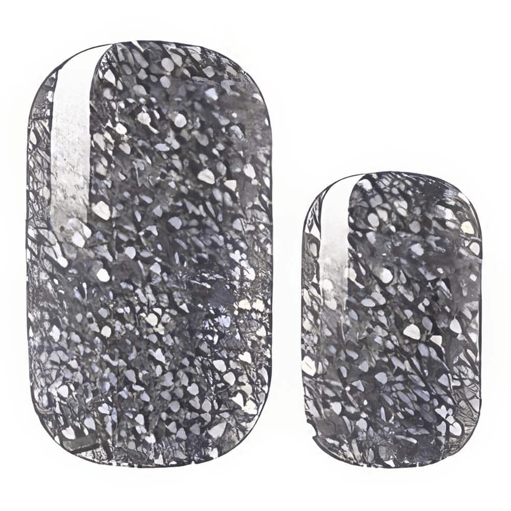Black and grey terrazzo-effect nail wraps with fine silver fleck detailing.
