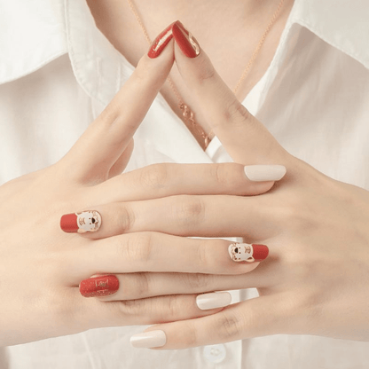 Tiger themed nail wraps in red and white showing playful character nail art on hands