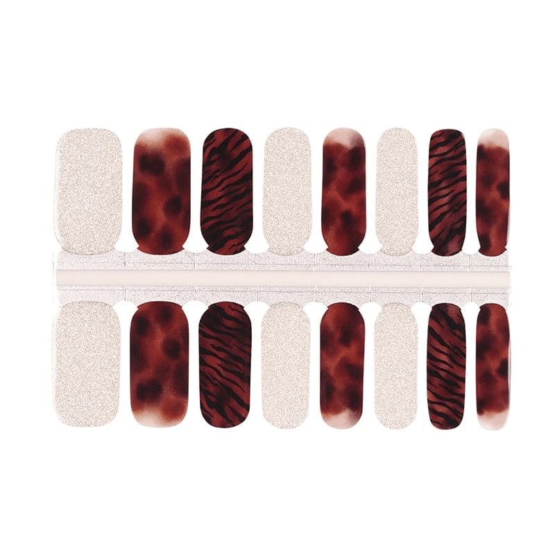 Non-UV nail wraps featuring bronze tiger stripes and silver glitter designs for at-home manicure