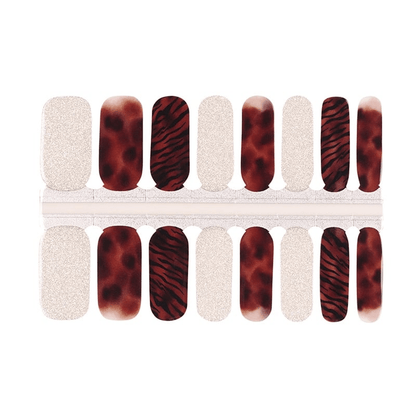 Non-UV nail wraps featuring bronze tiger stripes and silver glitter designs for at-home manicure