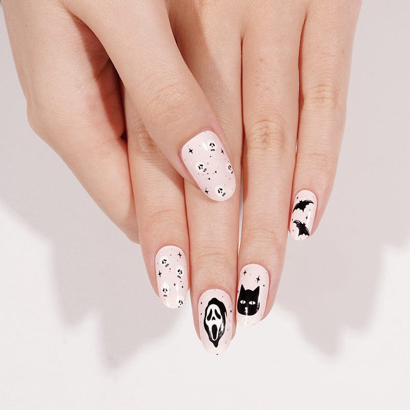 Gothic Halloween nail art with black and white ghost and cat designs