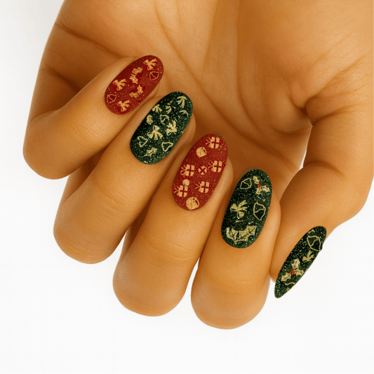 Christmas nail art with red and green festive patterns on hand showing at-home manicure