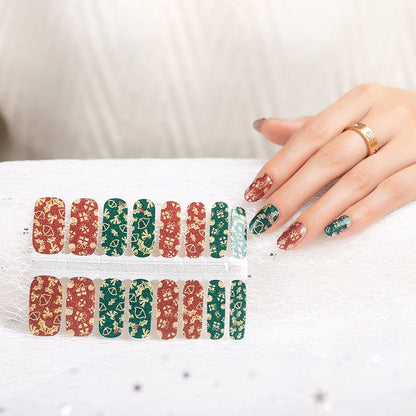 Christmas nail wrap collection sheet with hand wearing red and green holiday nail art