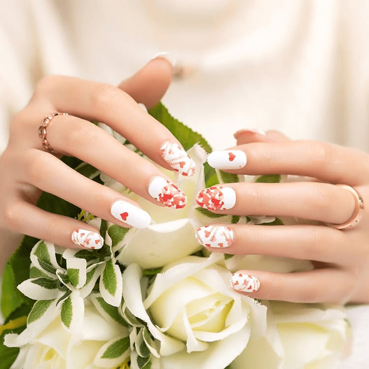 Valentine's heart nail wraps on hands holding white roses romantic red and white nail art