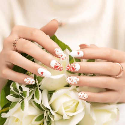 Valentine's heart nail wraps on hands holding white roses romantic red and white nail art