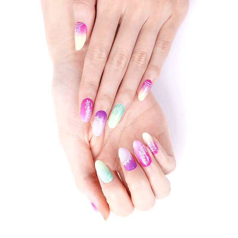 Hands wearing tropical mandala nail wraps in ombre pink purple mint gradient