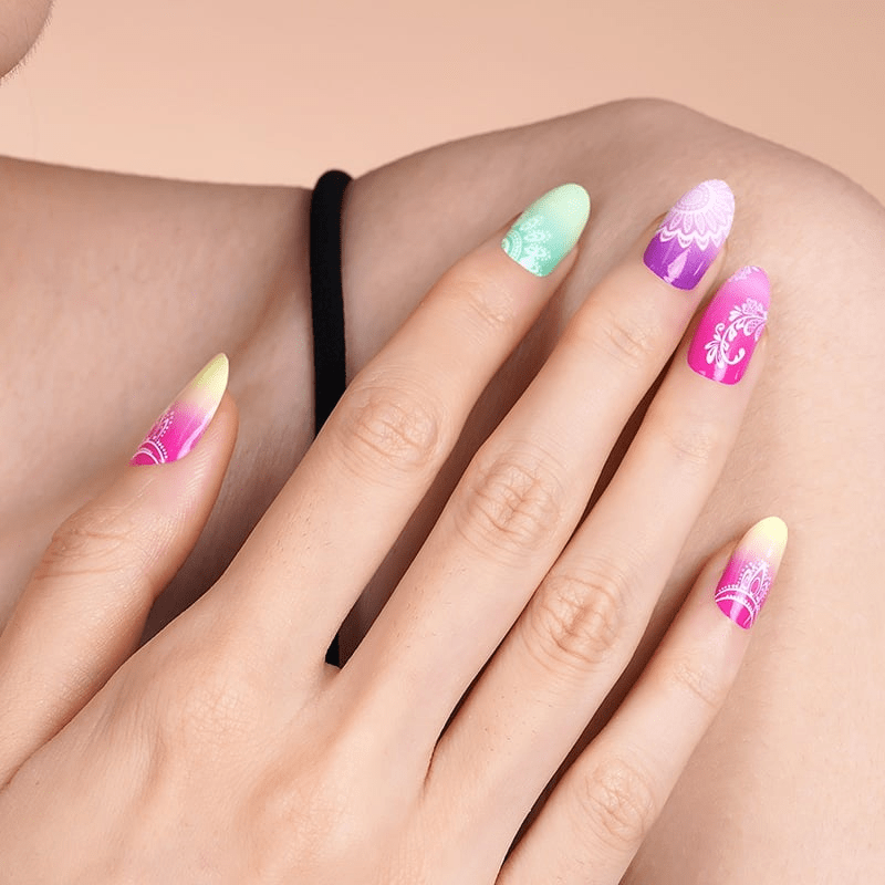 Close up of tropical mandala nail wraps on hand in gradient colours