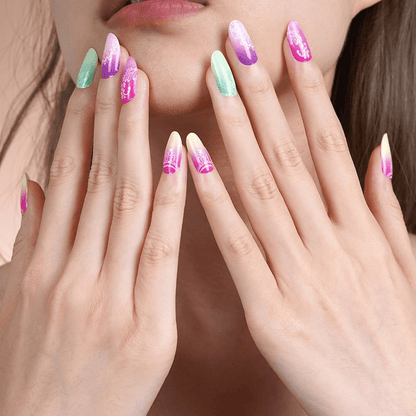Both hands displaying tropical ombre nail wraps with white mandala nail art