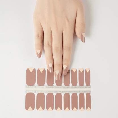 Hand displaying nude mauve geometric nail wraps with matching strip samples for DIY nails