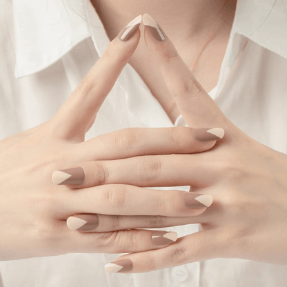 Hands showing nude brown geometric nail art with architectural colour block nail wrap design