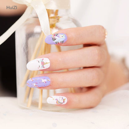 Hand holding golden perfume bottle wearing whimsical purple unicorn nail art wraps
