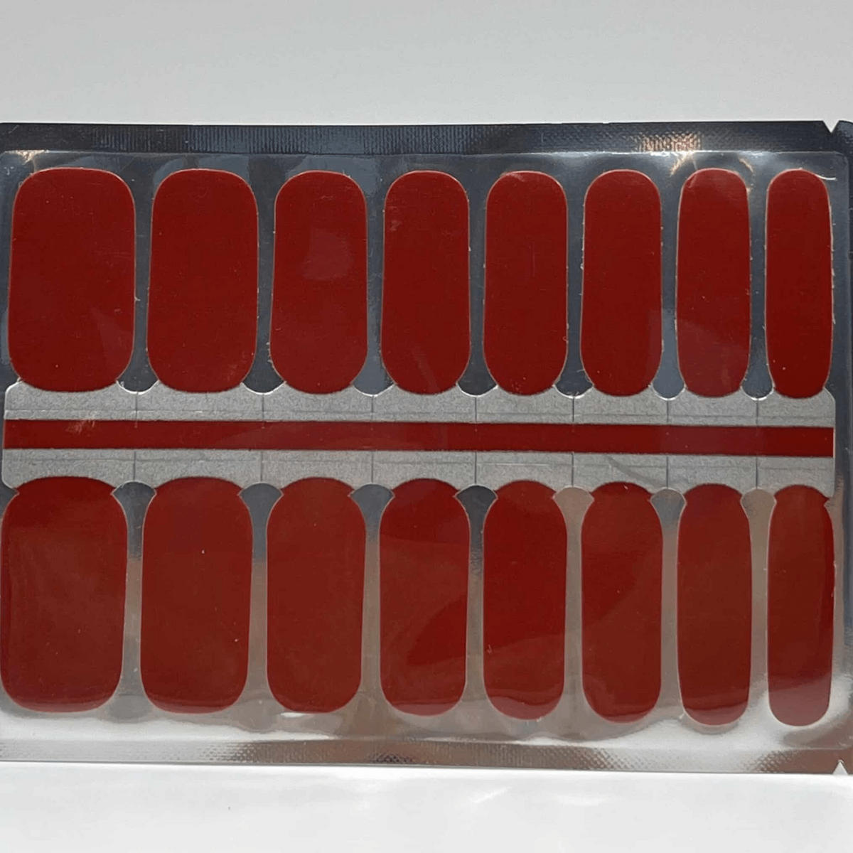Deep red glossy nail wraps, solid vermilion shade shown on sheet, high-shine finish
