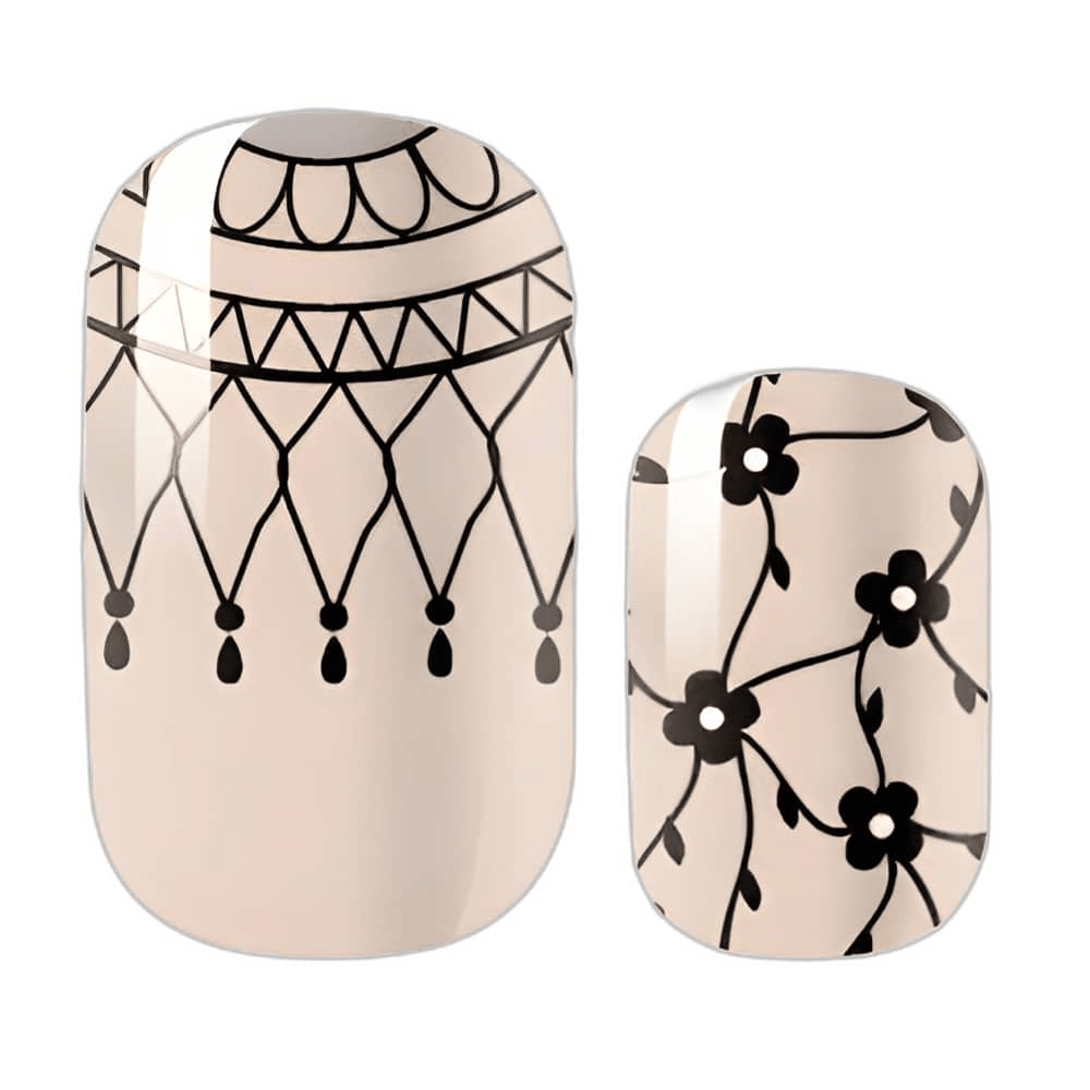 Close-up Victorian lace nail wraps with intricate black floral and geometric designs