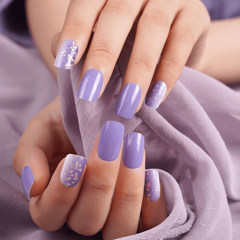 Purple nail wraps with glitter accent nails displayed on manicured hands