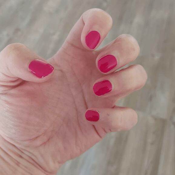 Glossy raspberry pink nail wraps in a solid high-shine finish on short round nails