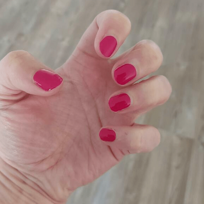 Glossy raspberry pink nail wraps in a solid high-shine finish on short round nails