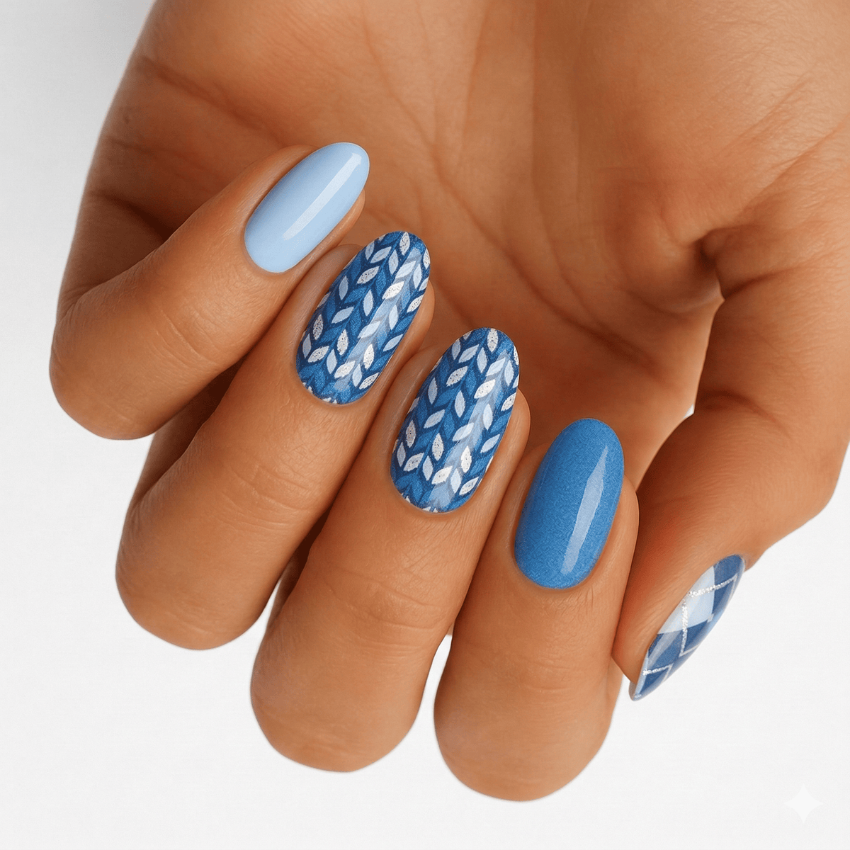 Blue wave pattern nail wraps on hand featuring geometric chevron design for DIY manicure