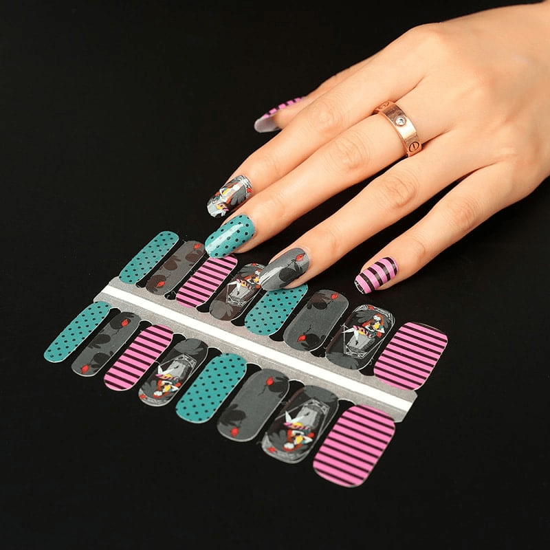 Non-UV nail wraps sheet showing gothic Halloween designs with black, teal, pink striped patterns