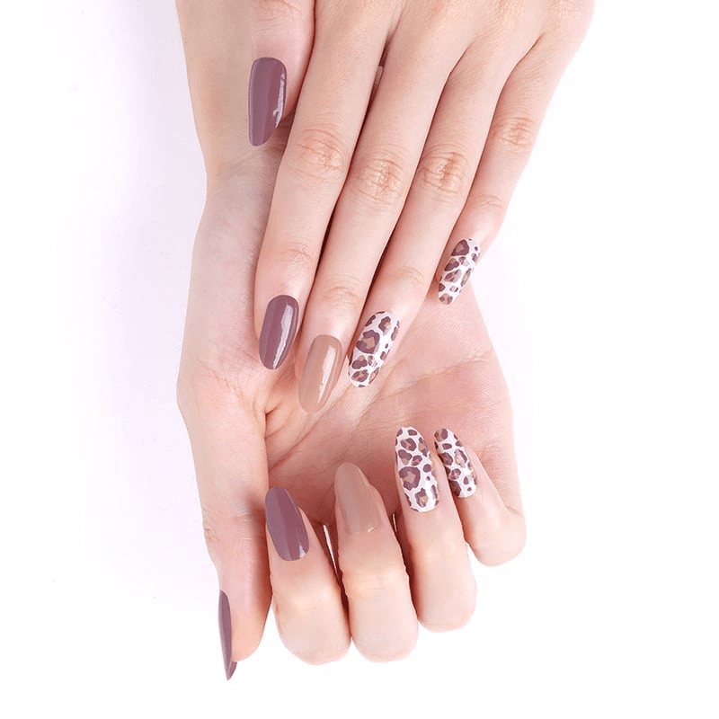 Hands wearing brown leopard print and plum non-UV nail wraps manicure design