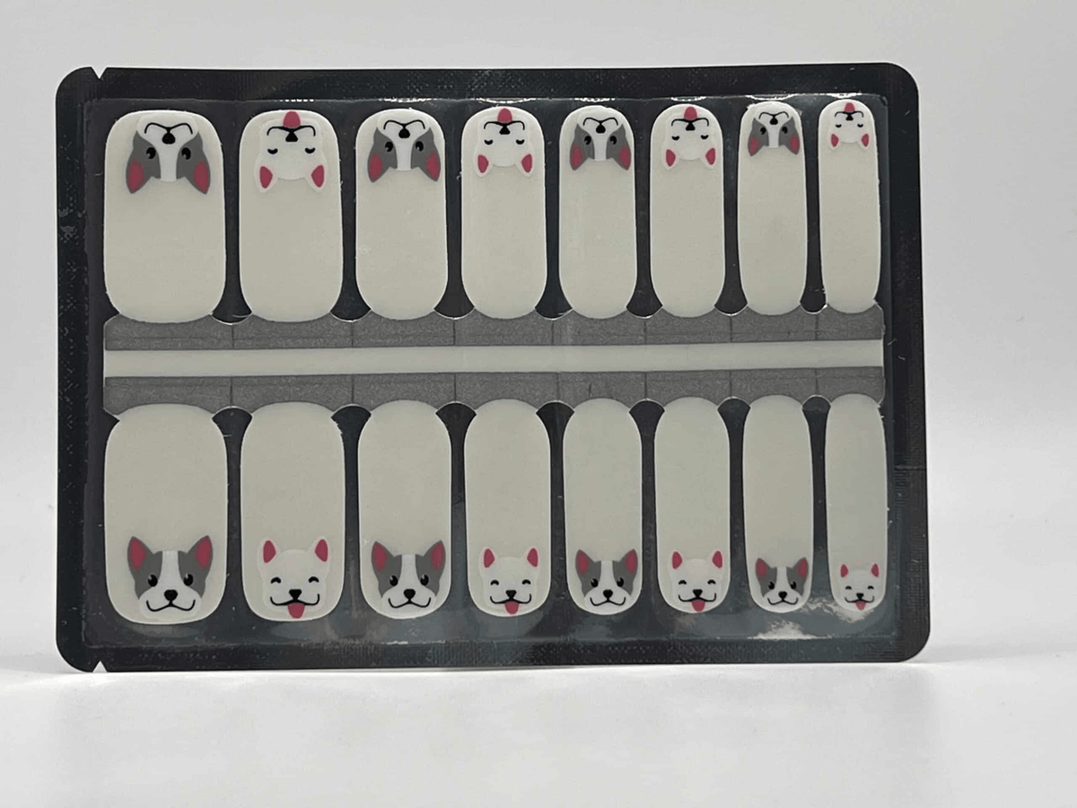 Animal themed nail wraps sheet with kawaii dog faces in grey and pink colours