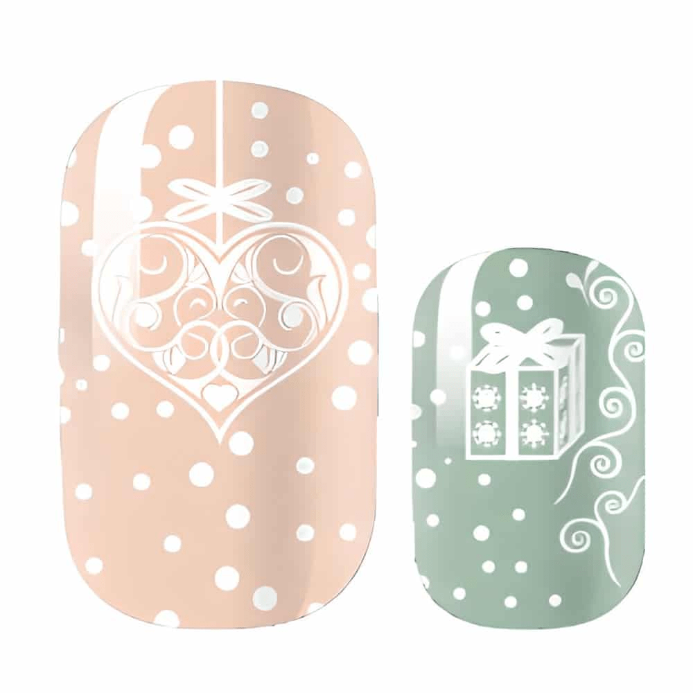 Close-up of Christmas nail art wraps featuring pink and green designs with white hearts and gift box motifs