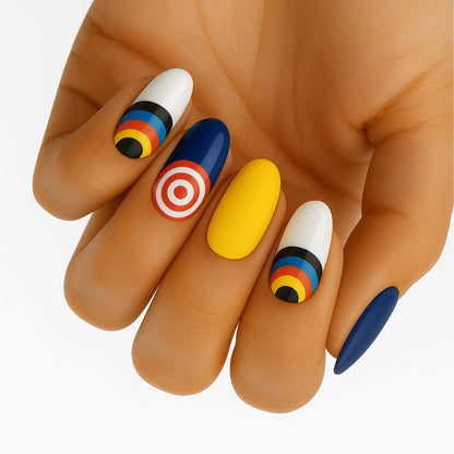Colourful target pattern nail wraps on hand featuring blue yellow white geometric nail art designs