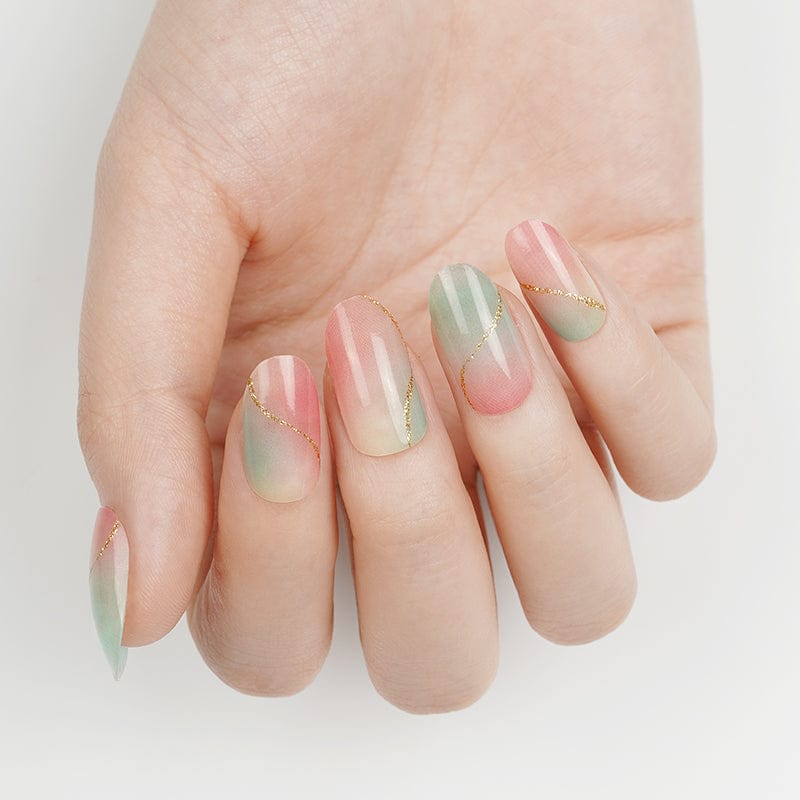 Pink mint green marble nail art wraps displayed on extended hand manicure