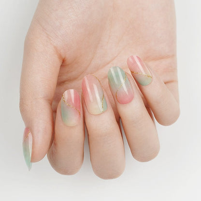 Pink mint green marble nail art wraps displayed on extended hand manicure