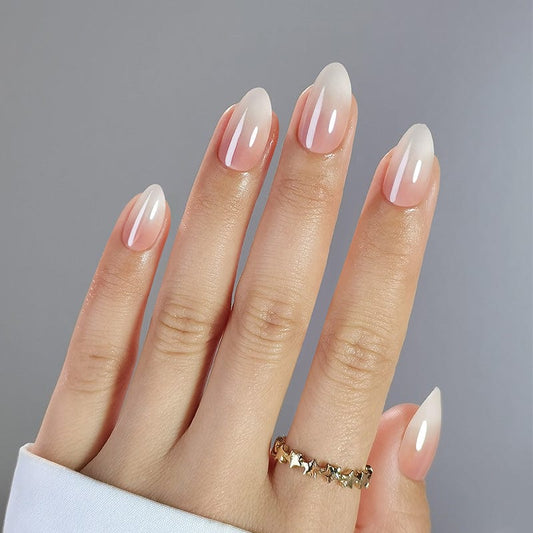 Short almond press-on nails in peachy pink glazed finish on hand