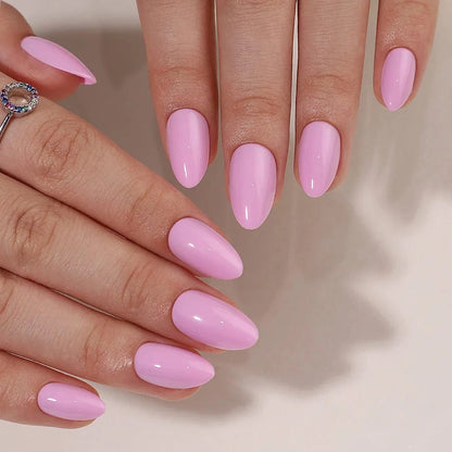Glossy pink gel press-on nails short almond manicure showing both hands with rings