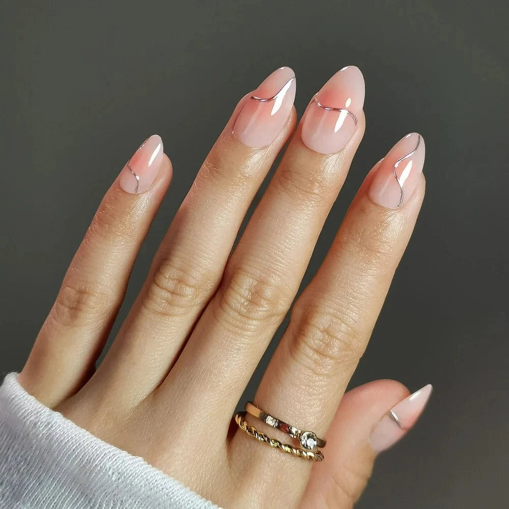 Short almond rose pink chrome press-on nails on hand with ring elegant manicure
