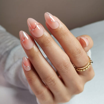 Glossy rose pink chrome press-on nails in short almond shape on hand