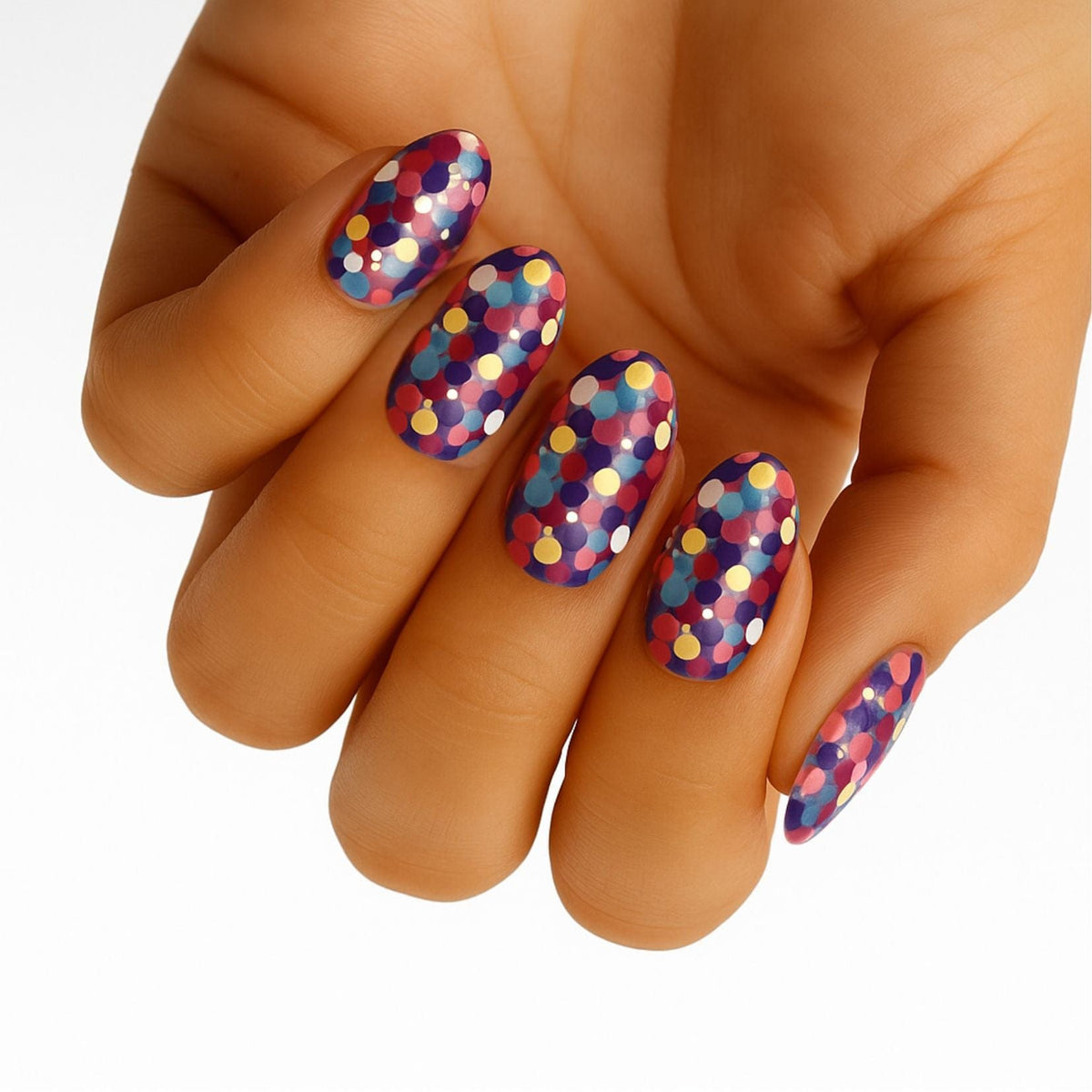 Colourful polka dot nail wraps on hand showing purple yellow multicoloured party manicure design