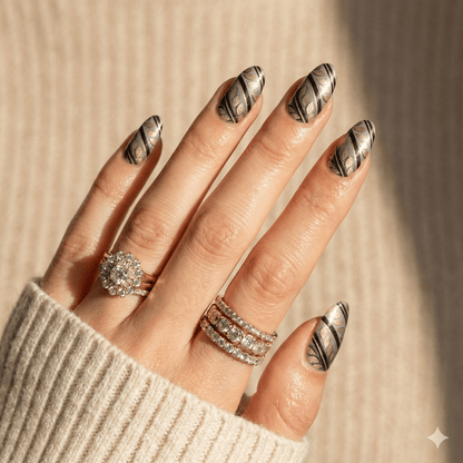 Silver chrome gel nail wraps with black art deco swirl pattern on hand