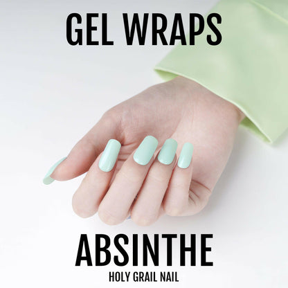 Hand wearing pastel mint green gel nail wraps for at-home manicure