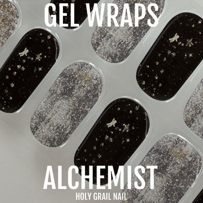 Black and silver glitter gel wraps with star nail art pattern close-up view