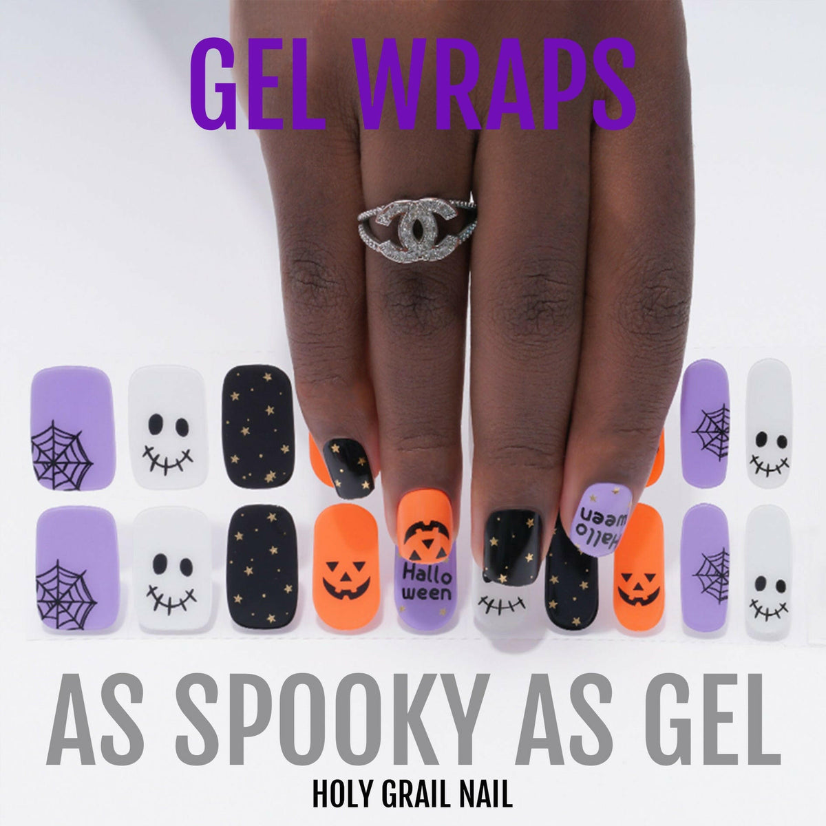 Halloween gel nail wraps on hand featuring orange pumpkins, black spiders, purple skulls