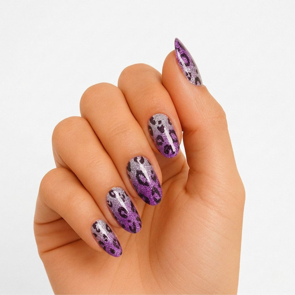 Purple leopard print gel nail wraps on hand showing animal print nail art design