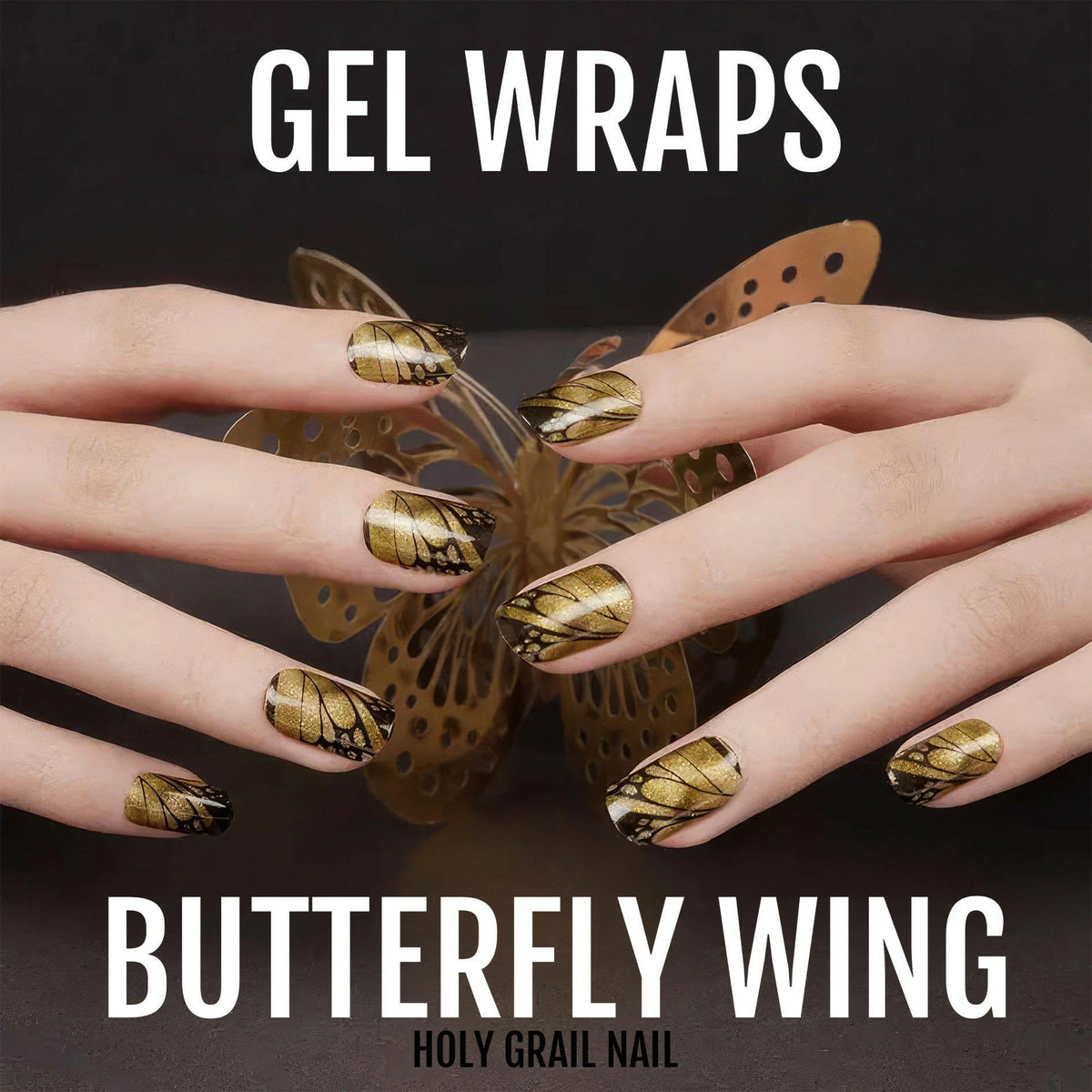 Hands wearing gold butterfly wing gel nail wraps with metallic brown and gold nail art