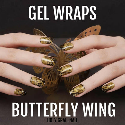 Hands wearing gold butterfly wing gel nail wraps with metallic brown and gold nail art
