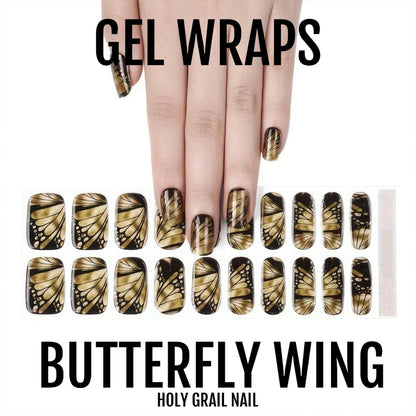 Golden butterfly wing gel nail wraps displayed on hand with matching nail art sheet