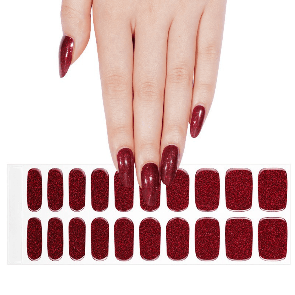 Hand wearing burgundy glitter gel nail wraps with matching nail wrap sheet