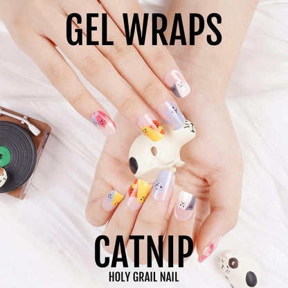 Hands displaying cute cat gel nail wraps featuring adorable kitten faces in multicoloured designs