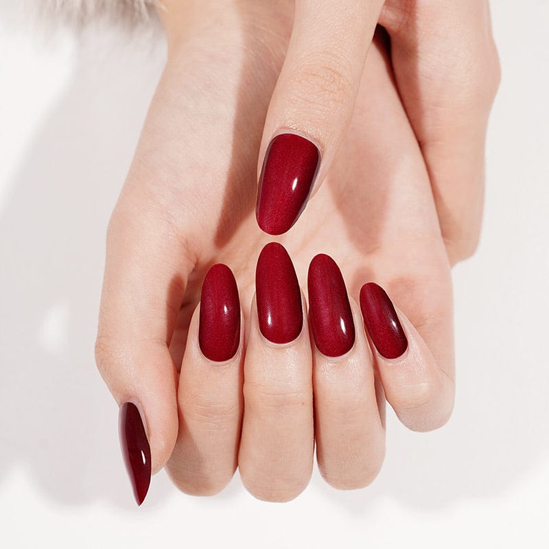 Cherry red gel nail wraps displayed on both hands showing glossy finish