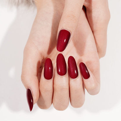 Cherry red gel nail wraps displayed on both hands showing glossy finish
