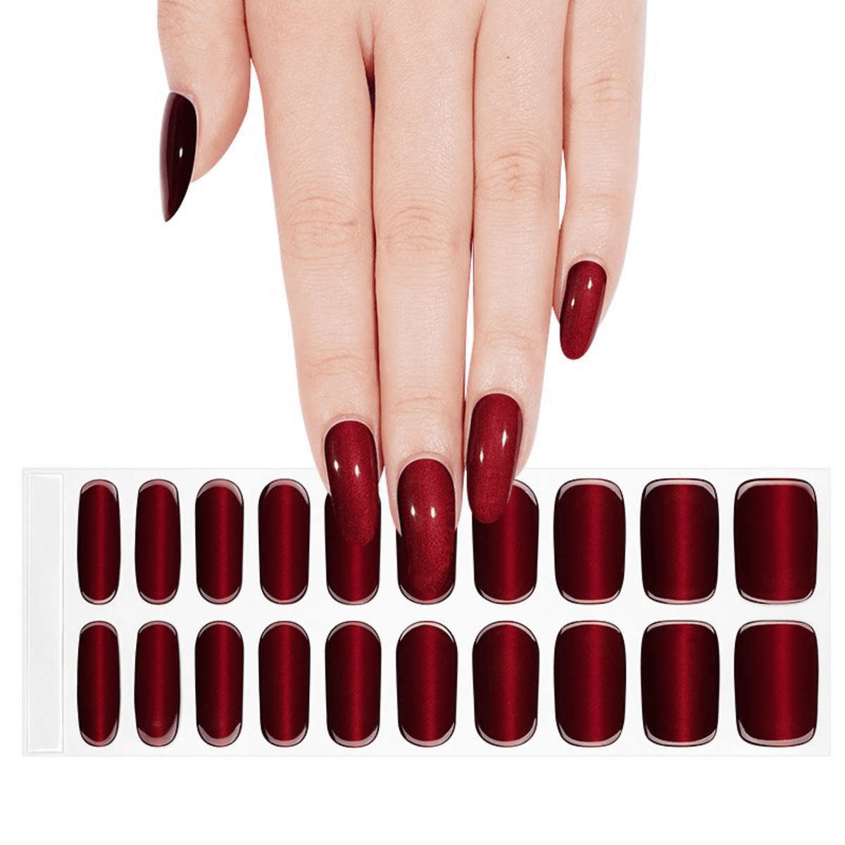 Hand displaying deep red glossy gel nail wraps with individual nail wrap sheet