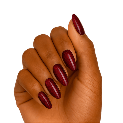 Deep red glossy gel nail wraps on hand showing cherry obsession manicure design